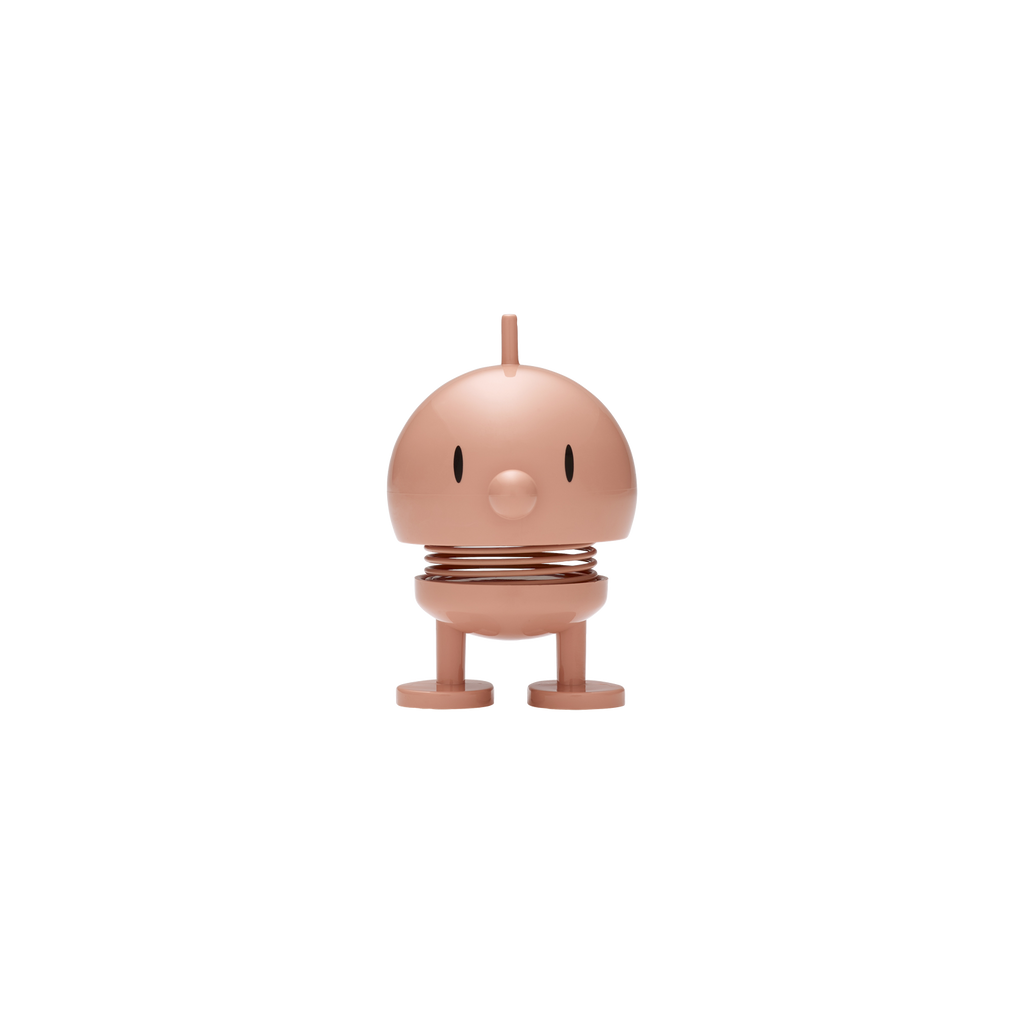 Melon-colored character figurine on a white background
