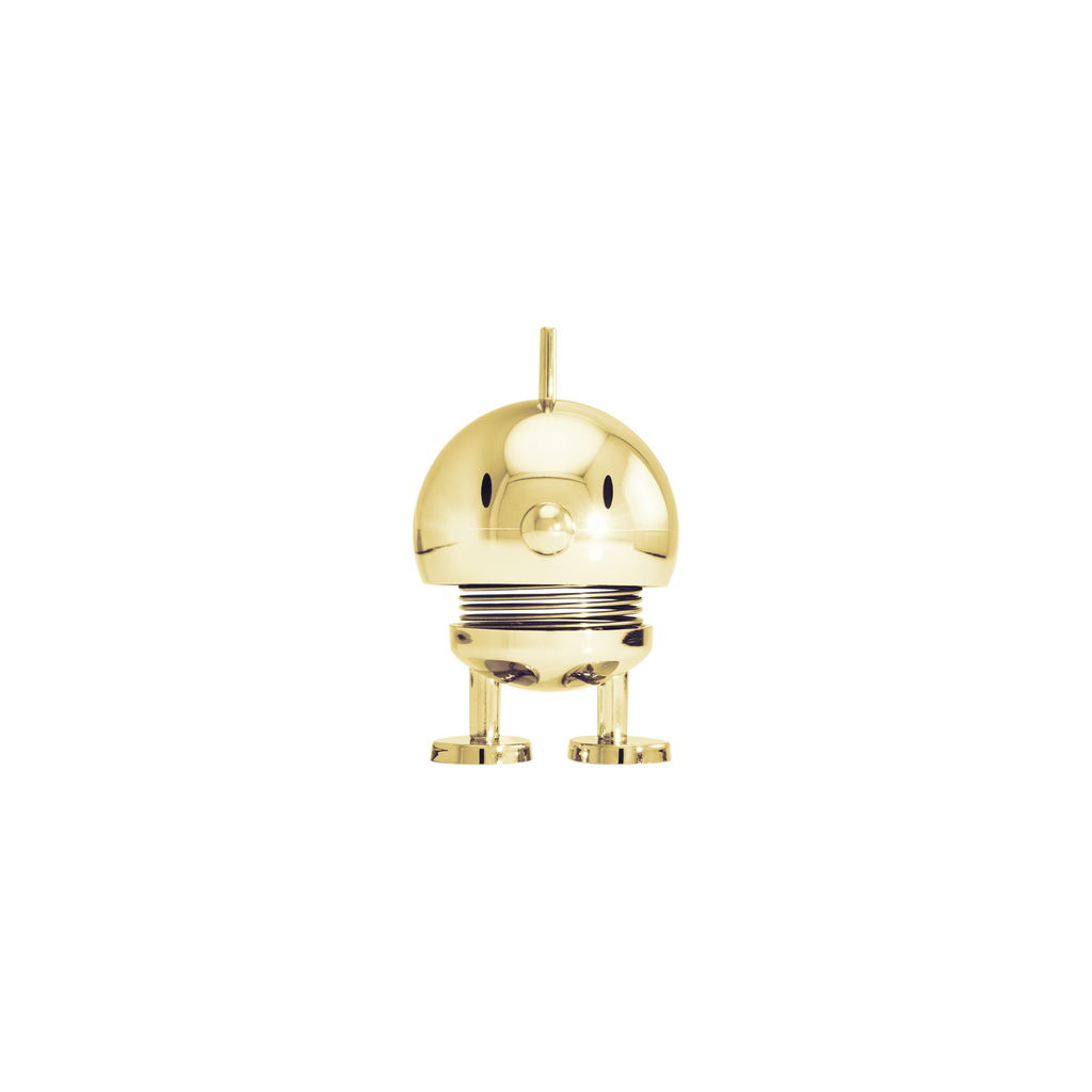 Gold-colored decorative object resembling a robot on a white background