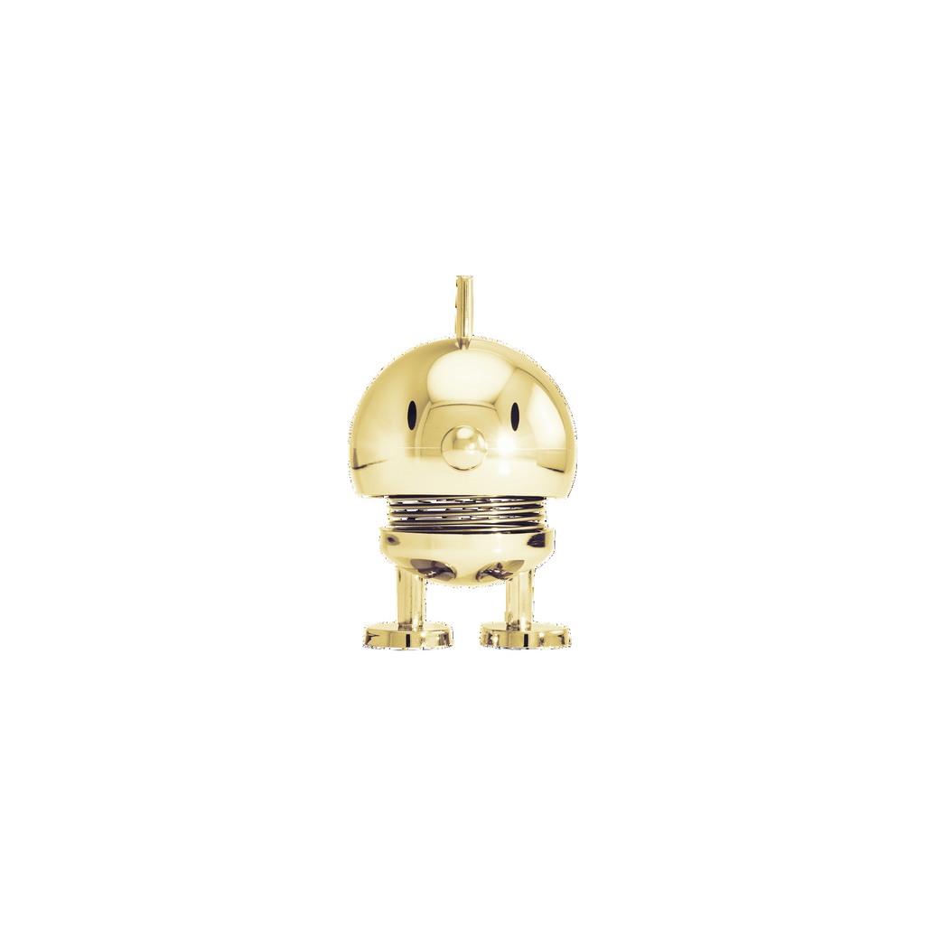 Gold-colored decorative object resembling a robot on a white background