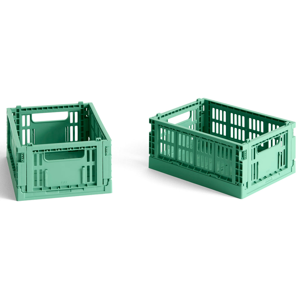 Two green crates on a white background