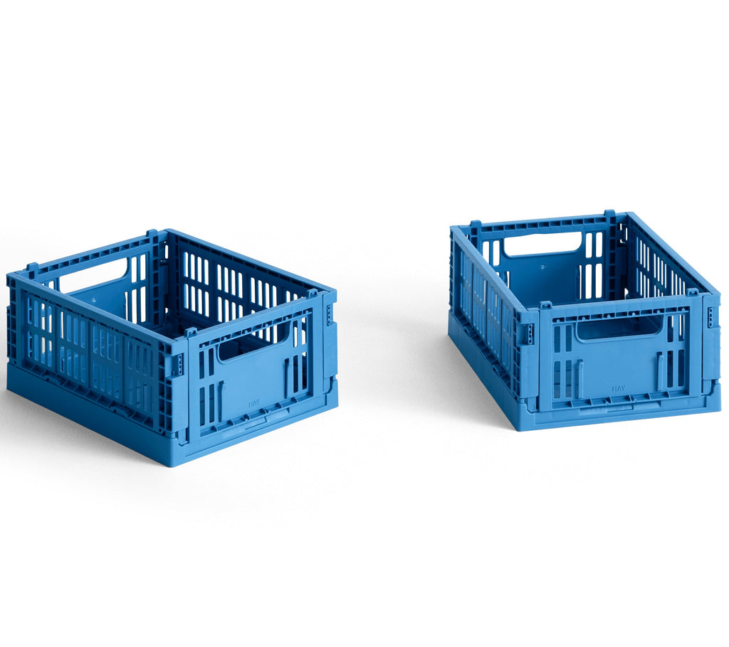 Two blue plastic crates on a white background