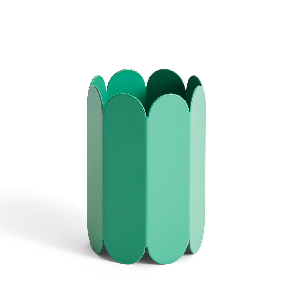 Green decorative item with scalloped edges on a white background