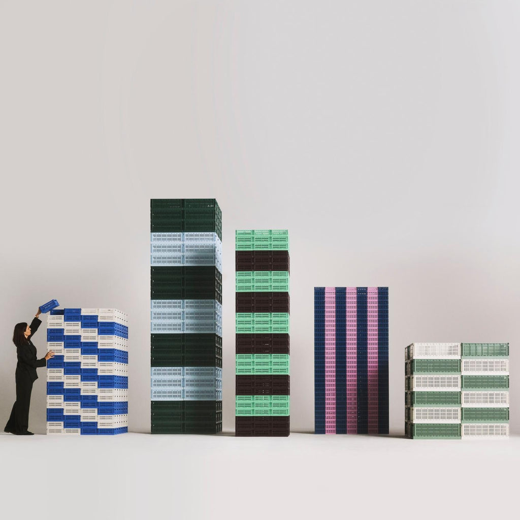 Stacks of colorful boxes of different heights on a white background