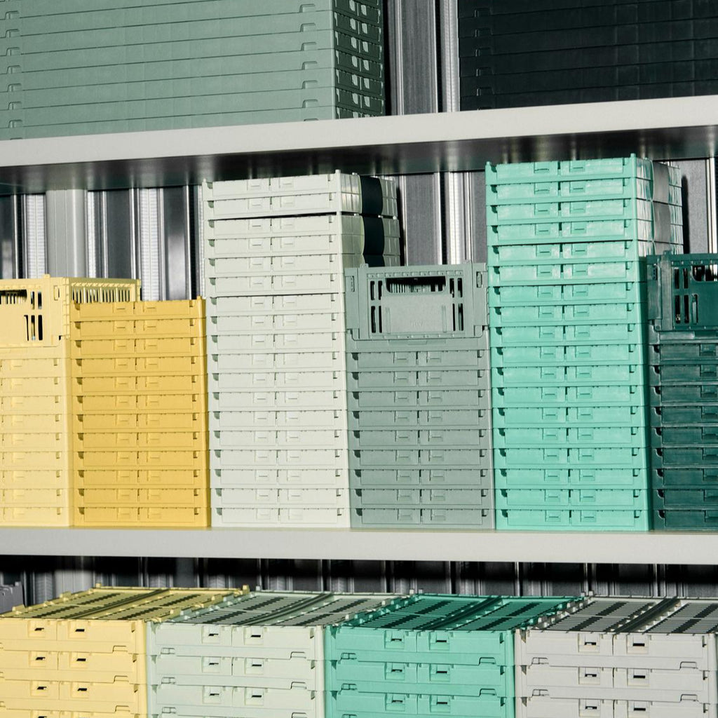 Stacks of colorful crates on a metal shelf