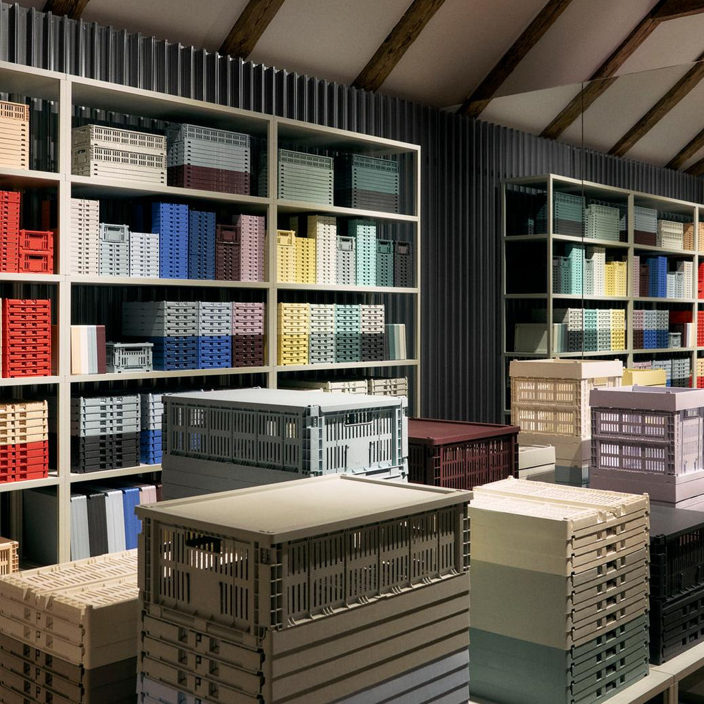 Storage room with shelves filled with colorful crates and boxes.