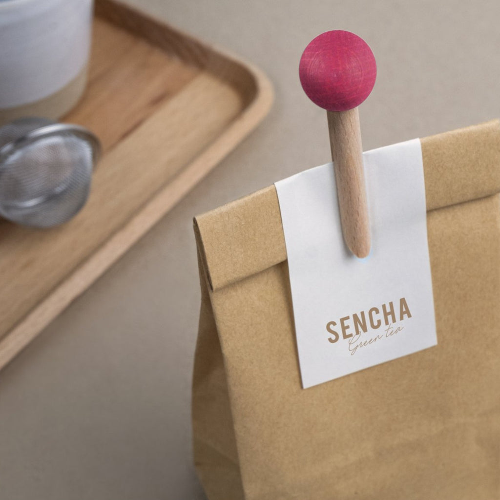brown and pink wooden bag clip on paper bag with the words sencha on it