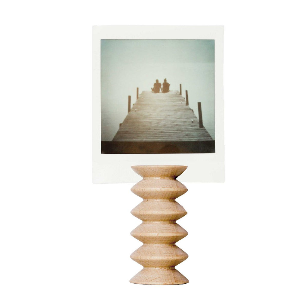 Wooden picture stand with a polaroid on top.