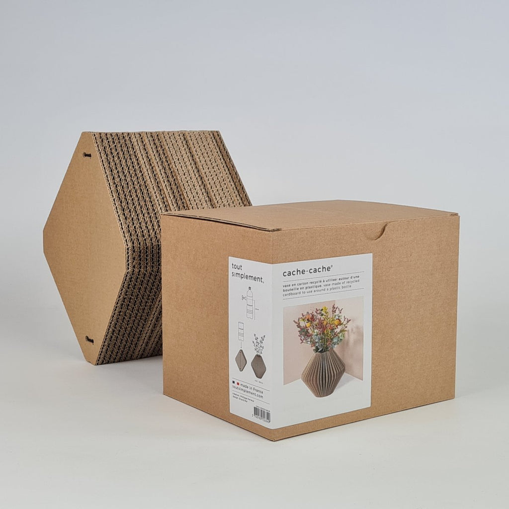 cardboard vase next to its cardboard packaging box with brand label
