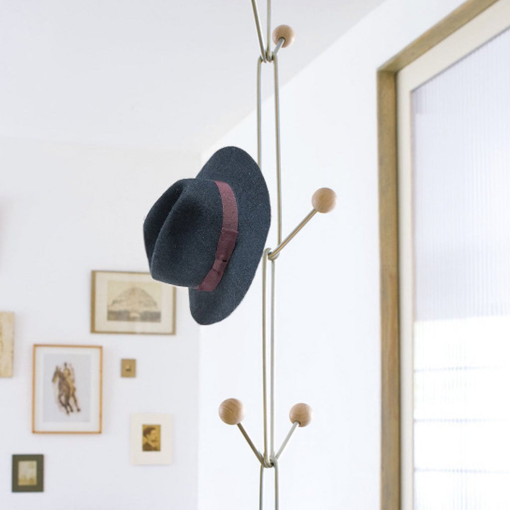 hanging coat rack with hat on it